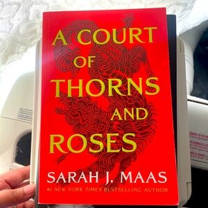 A Court of Thorns and Roses. First book to a series. Used. Slight fold wrinkle.